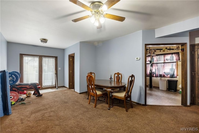 dining space featuring ceiling fan and carpet floors