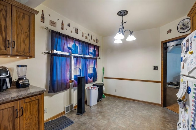 kitchen featuring decorative light fixtures and a chandelier