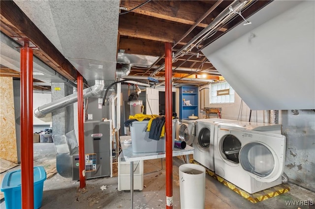 washroom with washing machine and dryer, water heater, and heating unit