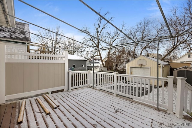 wooden deck featuring a garage and an outdoor structure