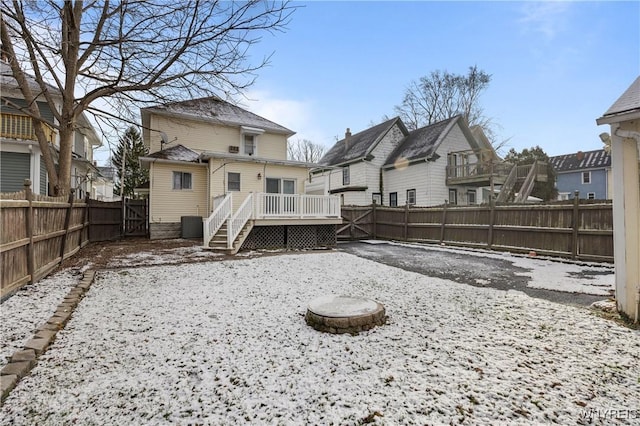 rear view of house featuring a deck and an outdoor fire pit