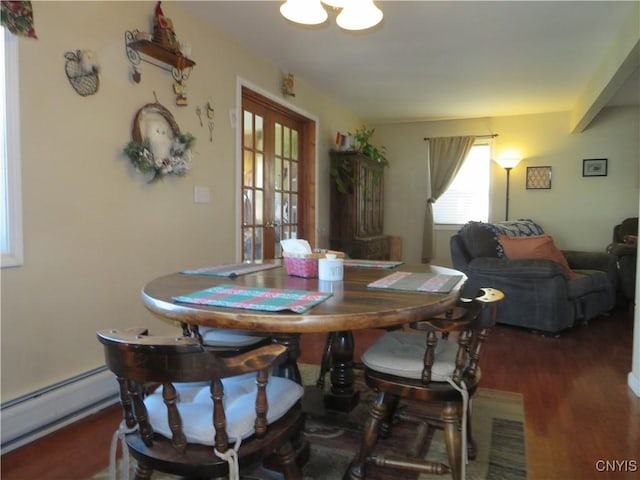 dining area with french doors, dark hardwood / wood-style flooring, and baseboard heating