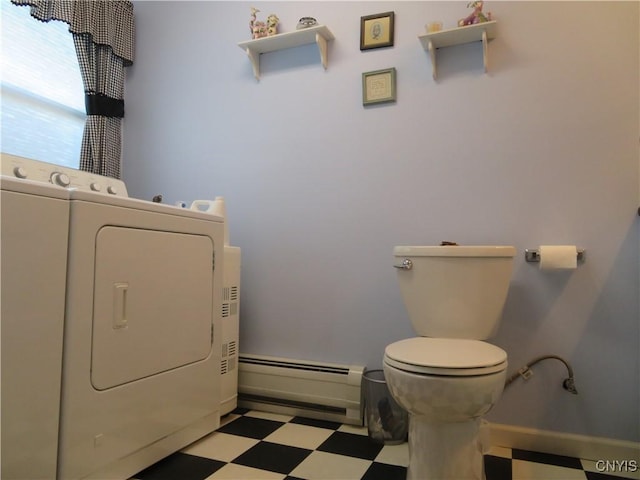 bathroom with washer and dryer, toilet, and baseboard heating