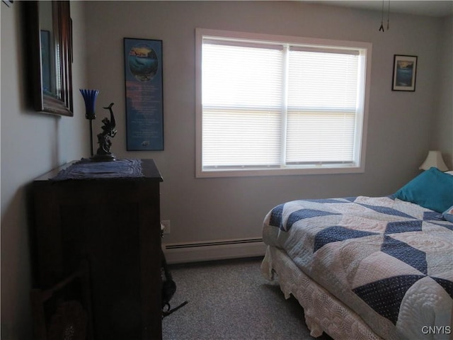 bedroom with baseboard heating and carpet