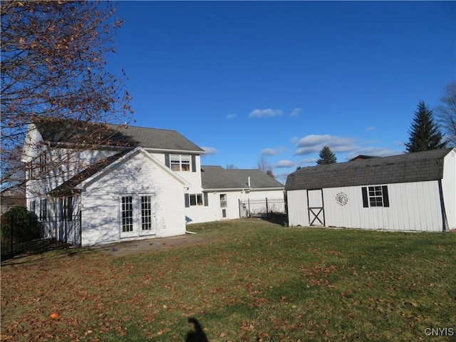 back of property featuring a yard and a shed