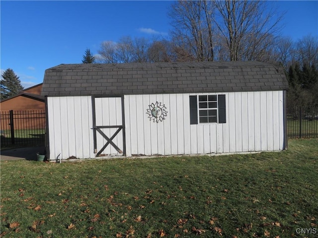 view of outbuilding featuring a lawn