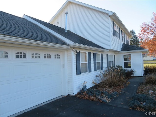 view of side of home featuring a garage