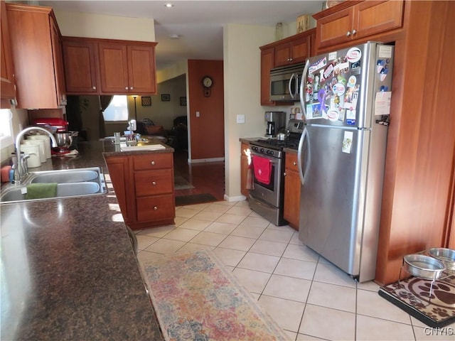 kitchen with sink, light tile patterned floors, and appliances with stainless steel finishes