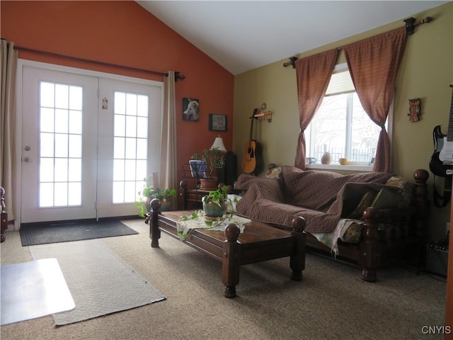 carpeted living room featuring lofted ceiling