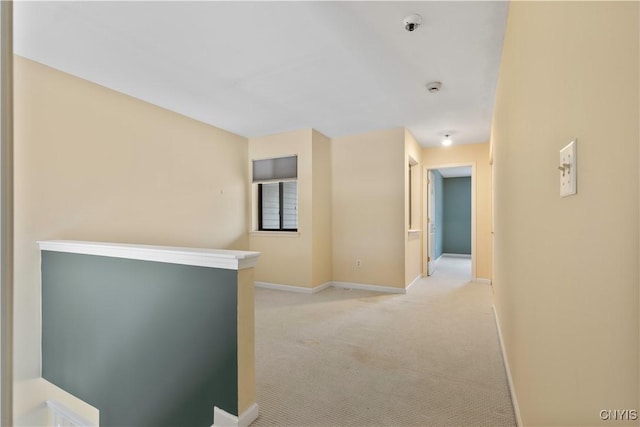 hallway with light colored carpet