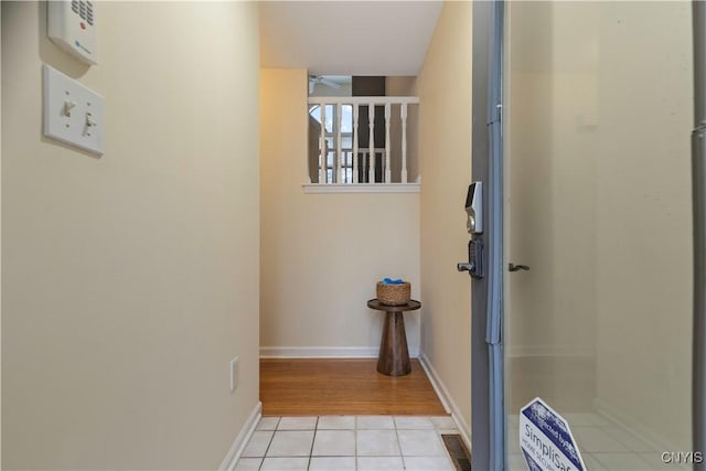 hall featuring light tile patterned floors