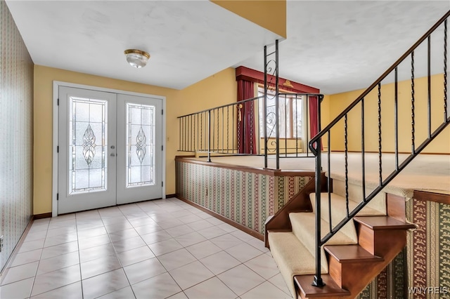 foyer featuring light tile patterned floors and french doors