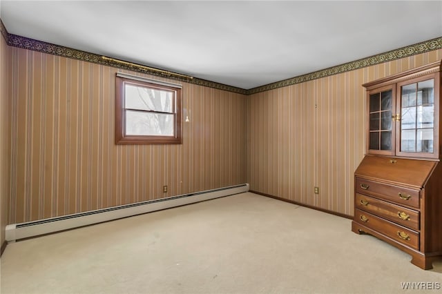 carpeted spare room with a baseboard radiator