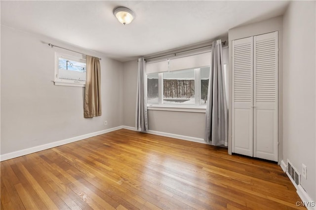 unfurnished bedroom featuring a closet and wood-type flooring