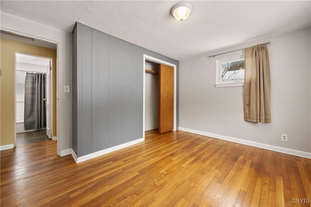 unfurnished bedroom with hardwood / wood-style floors and a closet