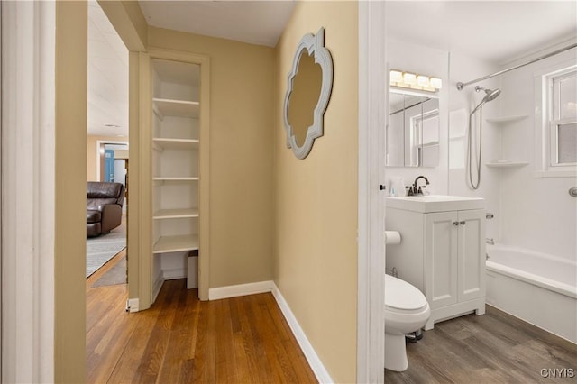 full bathroom with shower / bathing tub combination, toilet, vanity, and hardwood / wood-style flooring