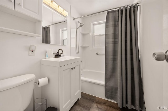 full bathroom with hardwood / wood-style flooring, shower / tub combo with curtain, vanity, and toilet