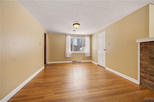 unfurnished room with hardwood / wood-style flooring