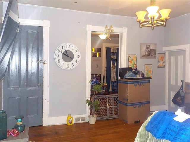 interior space featuring a notable chandelier and dark hardwood / wood-style flooring