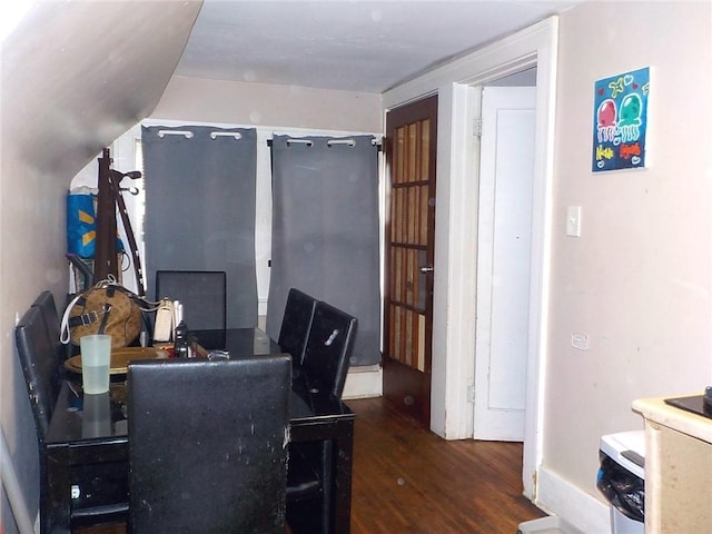 home office featuring lofted ceiling and dark wood-type flooring