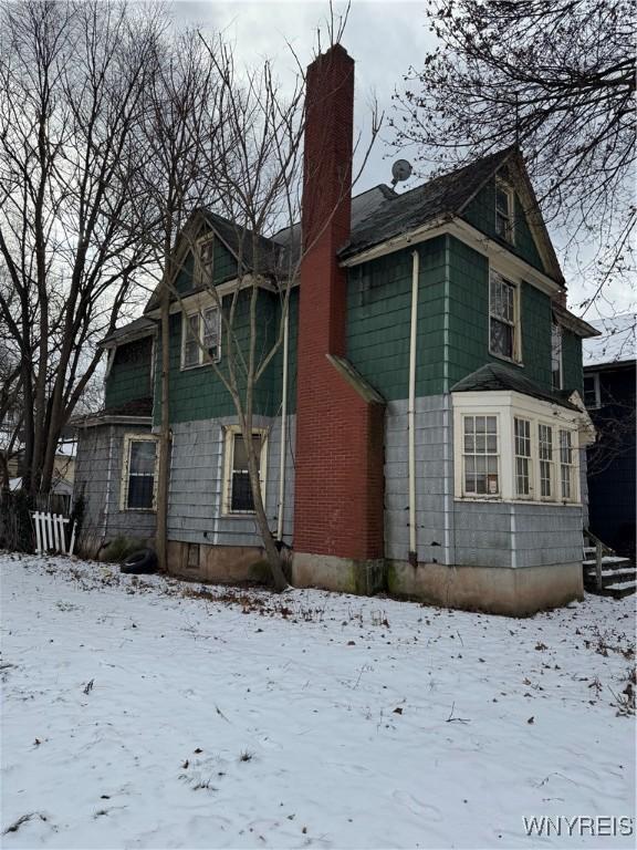 view of snow covered rear of property