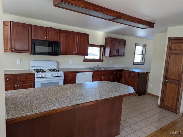 kitchen featuring sink, white appliances, and light wood-type flooring