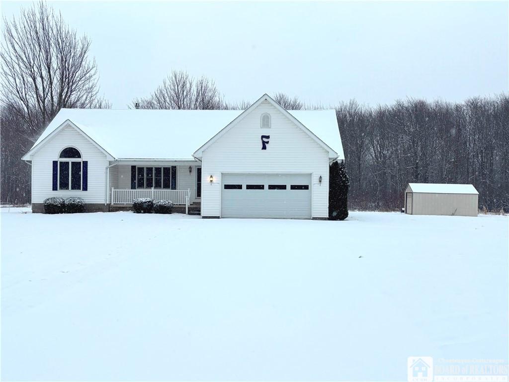 ranch-style home with a porch and a garage