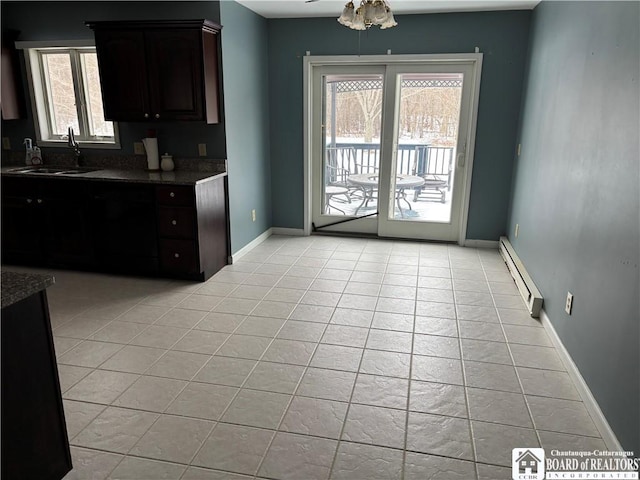 kitchen featuring sink, ceiling fan, light tile patterned floors, a baseboard heating unit, and dark brown cabinetry