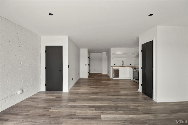 corridor featuring dark wood-type flooring and sink