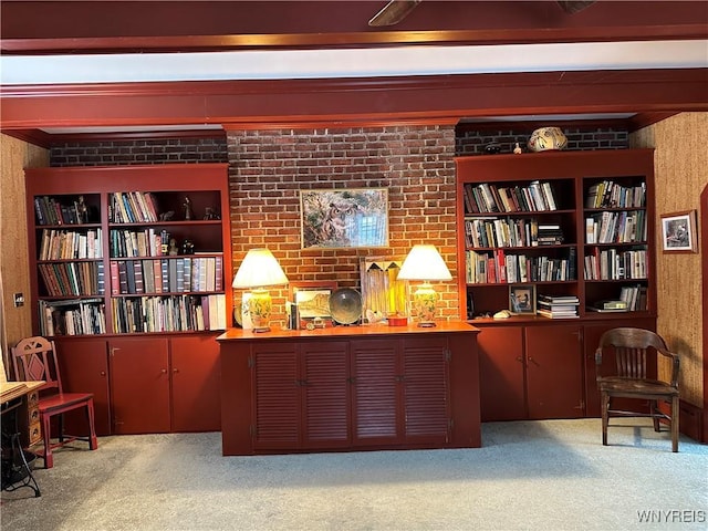 sitting room with brick wall and light colored carpet