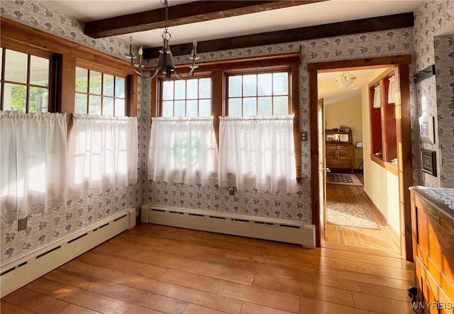 2721 Bowen Rd, Elma, NY 14059 - unfurnished dining area featuring light wood-type flooring, wallpapered walls, baseboard heating, a chandelier, and beam ceiling