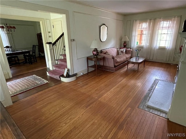 2721 Bowen Rd, Elma, NY 14059 - living room with stairway, hardwood / wood-style floors, crown molding, and a chandelier