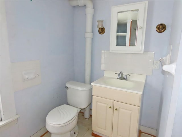 bathroom with toilet and vanity