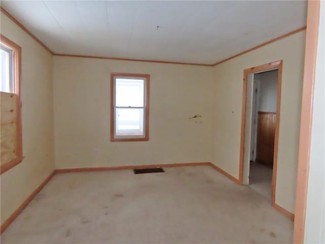 unfurnished room featuring light carpet