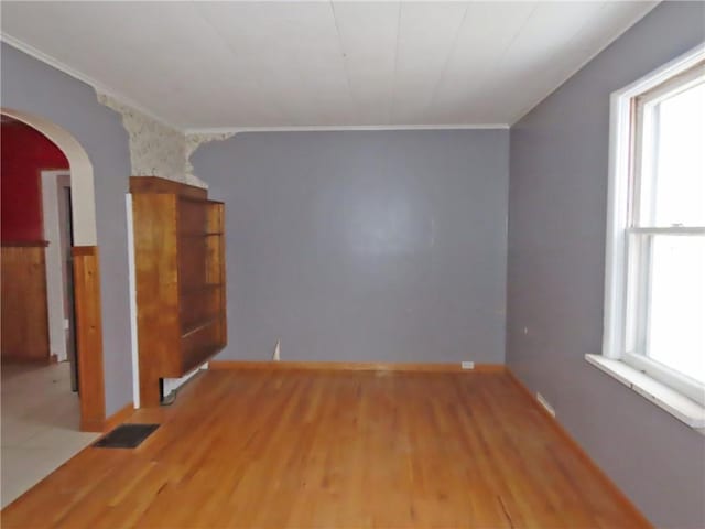 unfurnished room with crown molding and light hardwood / wood-style flooring