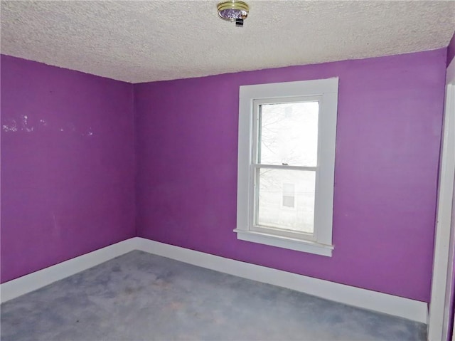 spare room featuring a textured ceiling and carpet floors