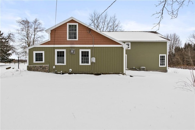 view of snow covered rear of property