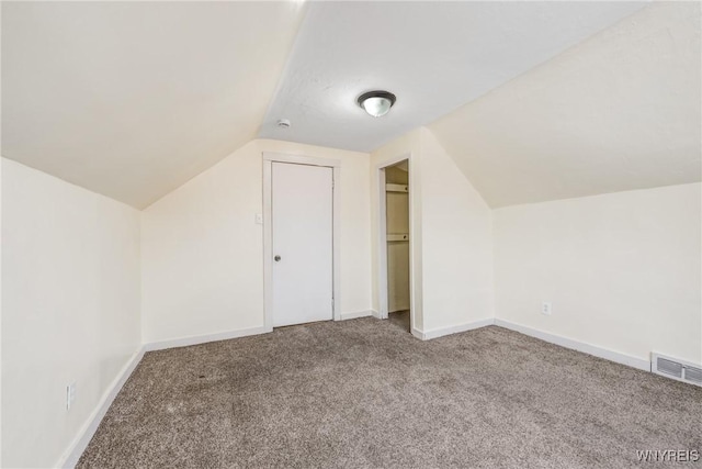 additional living space with lofted ceiling and carpet