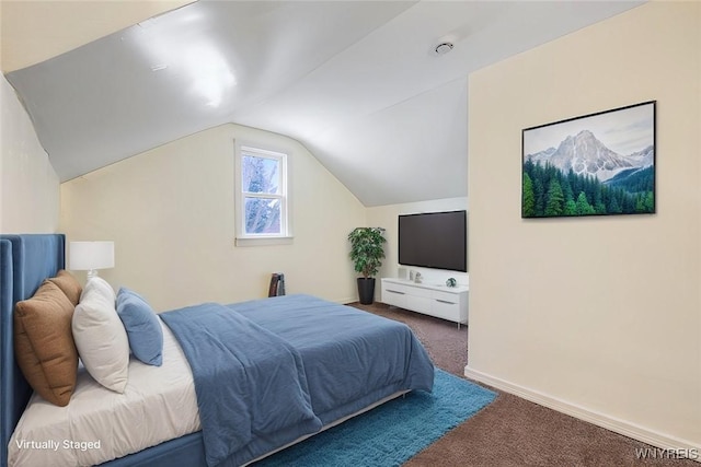 carpeted bedroom with vaulted ceiling