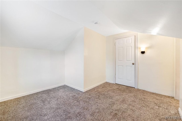 bonus room featuring lofted ceiling and carpet flooring