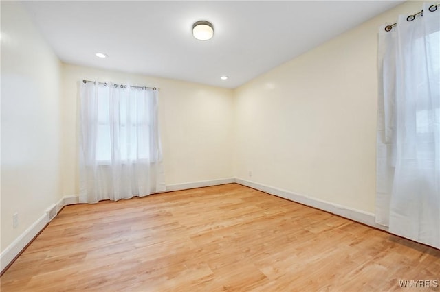 spare room with light hardwood / wood-style flooring