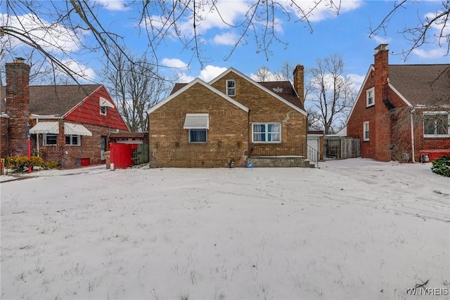 view of snow covered back of property