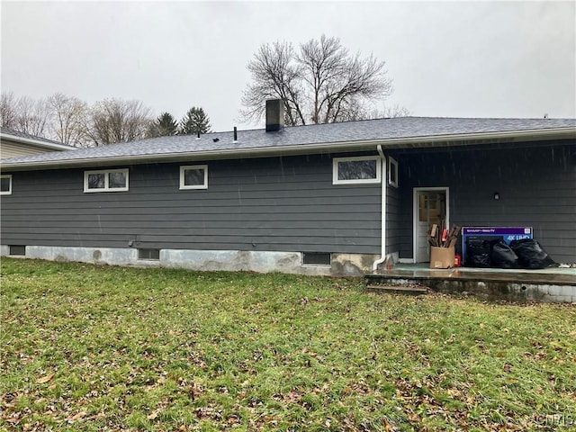 rear view of property with a yard