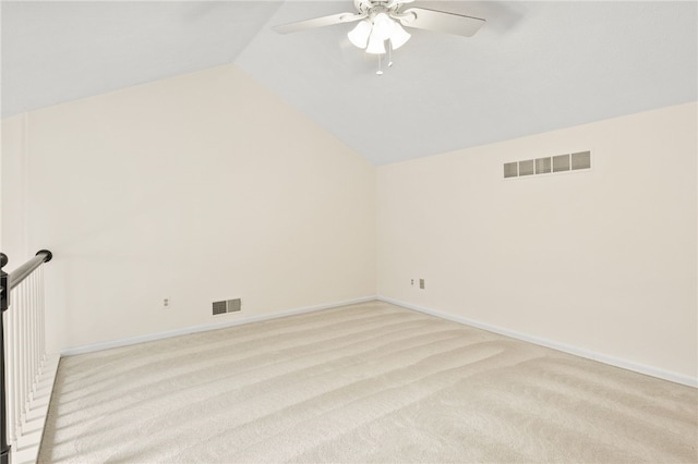 carpeted empty room featuring ceiling fan and vaulted ceiling