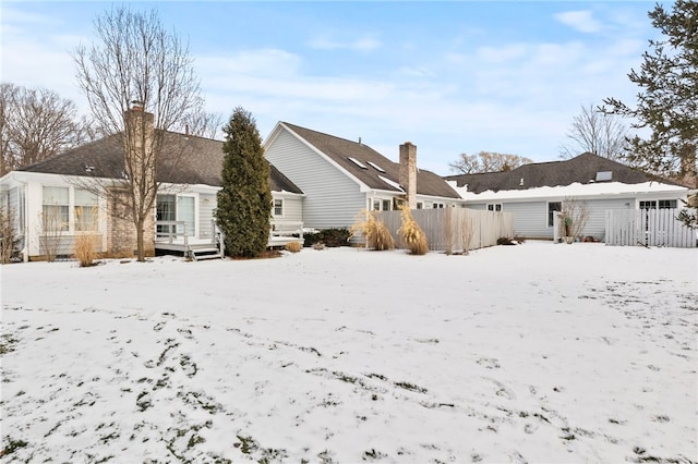 view of snow covered rear of property