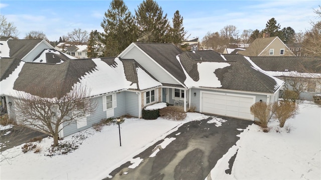 view of snow covered exterior featuring a garage