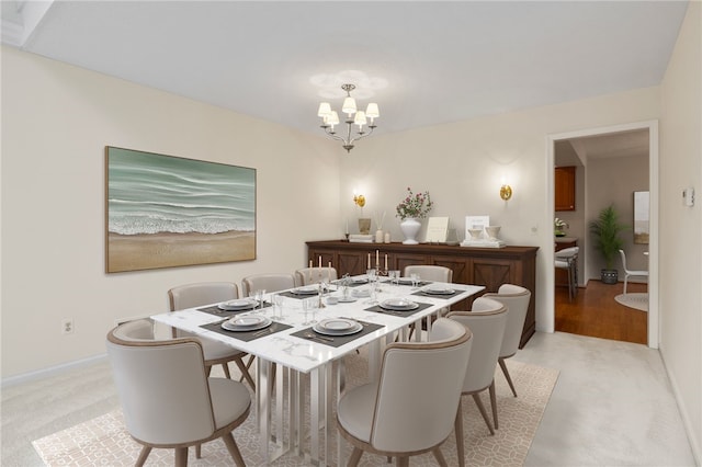 carpeted dining room featuring a notable chandelier