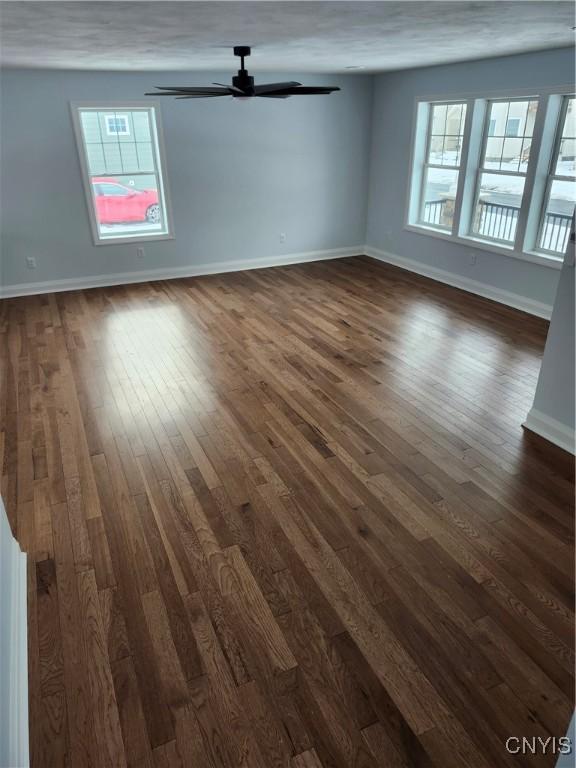 unfurnished room with ceiling fan and dark hardwood / wood-style floors