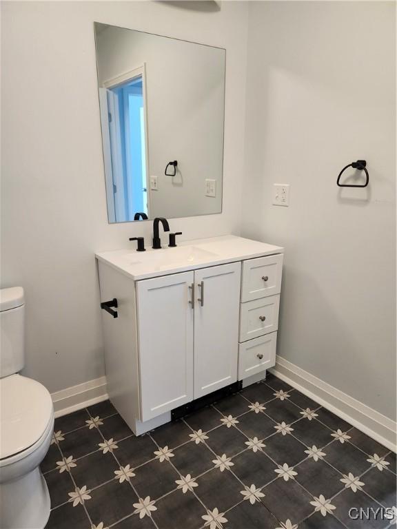 bathroom featuring toilet and vanity