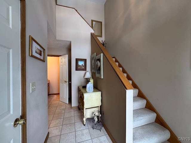 stairway featuring tile patterned floors